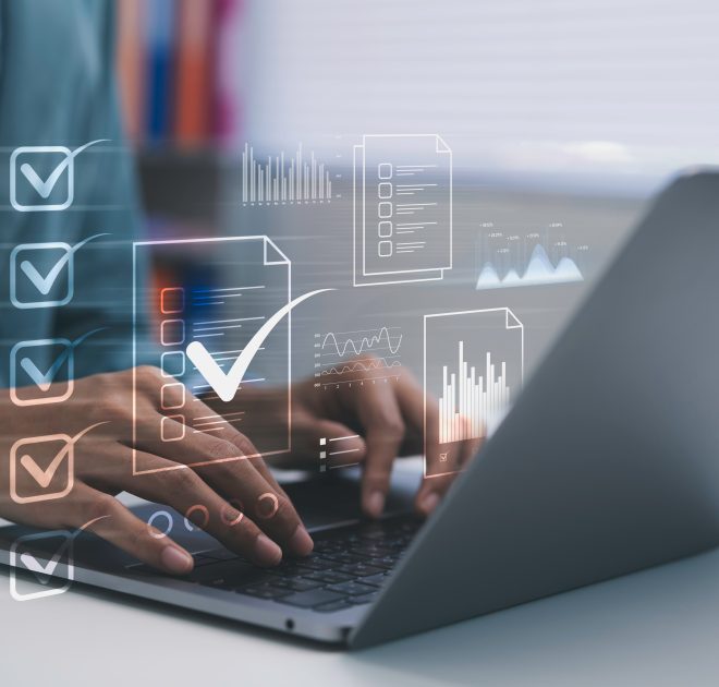 Business professional typing on laptop managing digital checklis